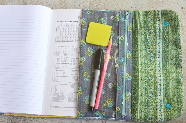 Make a composition book cover with a clear vinyl zip pouch to hold your pencils and pens!