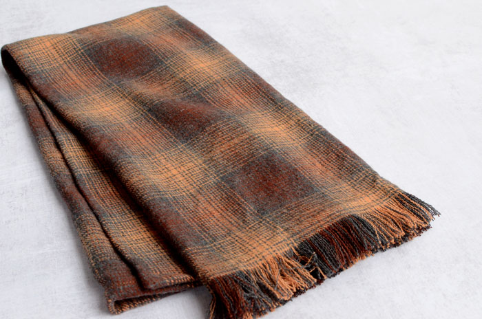 Folded flannel tea towel shown at an angle