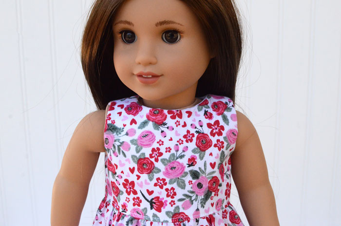 closeup of 18" doll wearing a sleeveless dress